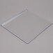 A clear plastic splash shield on a white surface.