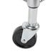 A close-up of a black and silver wheel on a metal base.