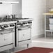 A commercial stainless steel 6-burner range with an oven, designed for professional kitchens.