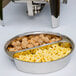 A white Acopa Supreme divided round food pan filled with pasta and meatballs.