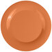 A close-up of a white melamine plate with a pumpkin design in the center.