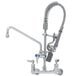 A chrome T&S pre-rinse faucet with a hose attached.