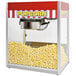 A Paragon Classic Pop popcorn machine with a red and white striped awning.