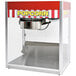 A Paragon Classic Pop popcorn machine with a red and white striped awning.