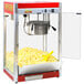 A Paragon commercial popcorn machine with a yellow bowl and red lid.