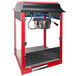 A red and black Paragon 1911 Original Popcorn Machine with a lid.