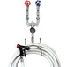 A T&S washdown station with valves, hoses, and a hose rack.