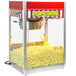 A Paragon Classic Pop popcorn machine with a red and white striped awning.