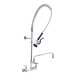 A T&S wall mount pet grooming faucet with a hose and a sprayer.