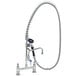 A chrome T&S pet grooming faucet with a hose.