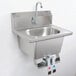 A stainless steel Eagle Group wall mount hand sink with gooseneck faucet and knee pedals.