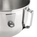 A stainless steel KitchenAid mixing bowl with a handle.