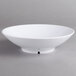 A white Carlisle melamine vegetable bowl on a gray surface.