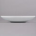 A Tablecraft white cast aluminum triangle display bowl.