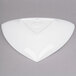 A white triangle shaped cast aluminum display bowl.