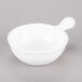 A Tablecraft white cast aluminum soup bowl with a handle.