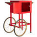 A red Carnival King cart for a PM850 popcorn popper with wheels.