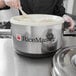 A man using a Town sushi rice container to serve rice.