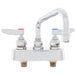 A chrome T&S deck-mounted workboard faucet with two handles and a swing nozzle.
