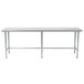 A stainless steel Advance Tabco work table with metal legs and an open base.