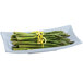 A Tablecraft gray cast aluminum flared rectangular platter with asparagus and lemon zest.