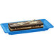 A rectangular piece of chocolate cake on a Tablecraft sky blue cast aluminum rectangular platter.