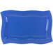 A blue rectangular Tablecraft platter with wavy edges.