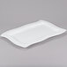 A white rectangular Tablecraft cast aluminum platter with a wavy edge.