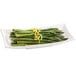 A Tablecraft white cast aluminum flared rectangle platter with asparagus and lemon zest.