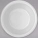 A Carlisle white fluted melamine ramekin on a gray surface.