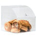 A clear plastic container with bagels inside.