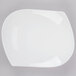 A CAC bone white porcelain peach plate with a curved edge.