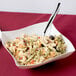 A Fineline ivory plastic serving bowl filled with pasta salad with a spoon and fork.