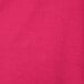 A close up of a hot magenta pink Creative Converting table cover with a textured pattern.
