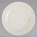 A white melamine saucer with a circular edge on a gray surface.
