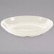 A Diamond Ivory melamine bowl with a rim on a gray background.