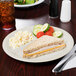 A GET Diamond Ivory melamine plate with food on it.