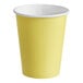 A yellow paper cup with a white rim.