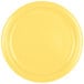 A close-up of a Creative Converting Mimosa Yellow paper plate.