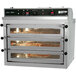 A large Doyon pizza oven with three trays of pizza inside.