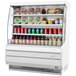 A white Turbo Air air curtain merchandiser filled with drinks and food.