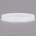 A close up of a white Cambro translucent lid with a straw slot.