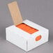 A white box with orange laminated twist ties inside.