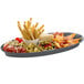 A Tablecraft granite cast aluminum King Fish platter with food, olives, and cheese on it.