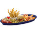 A blue Tablecraft cast aluminum platter with food, cheese, and olives.