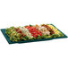 A Tablecraft rectangular platter with a salad on it.