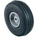 A black tire with a silver rim on a white background.
