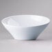 A close-up of a white Elite Global Solutions Pappasan melamine bowl.