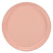 A pink Cambro round tray with a white background.