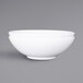 A close-up of a white Elite Global Solutions Sunburst melamine bowl.
